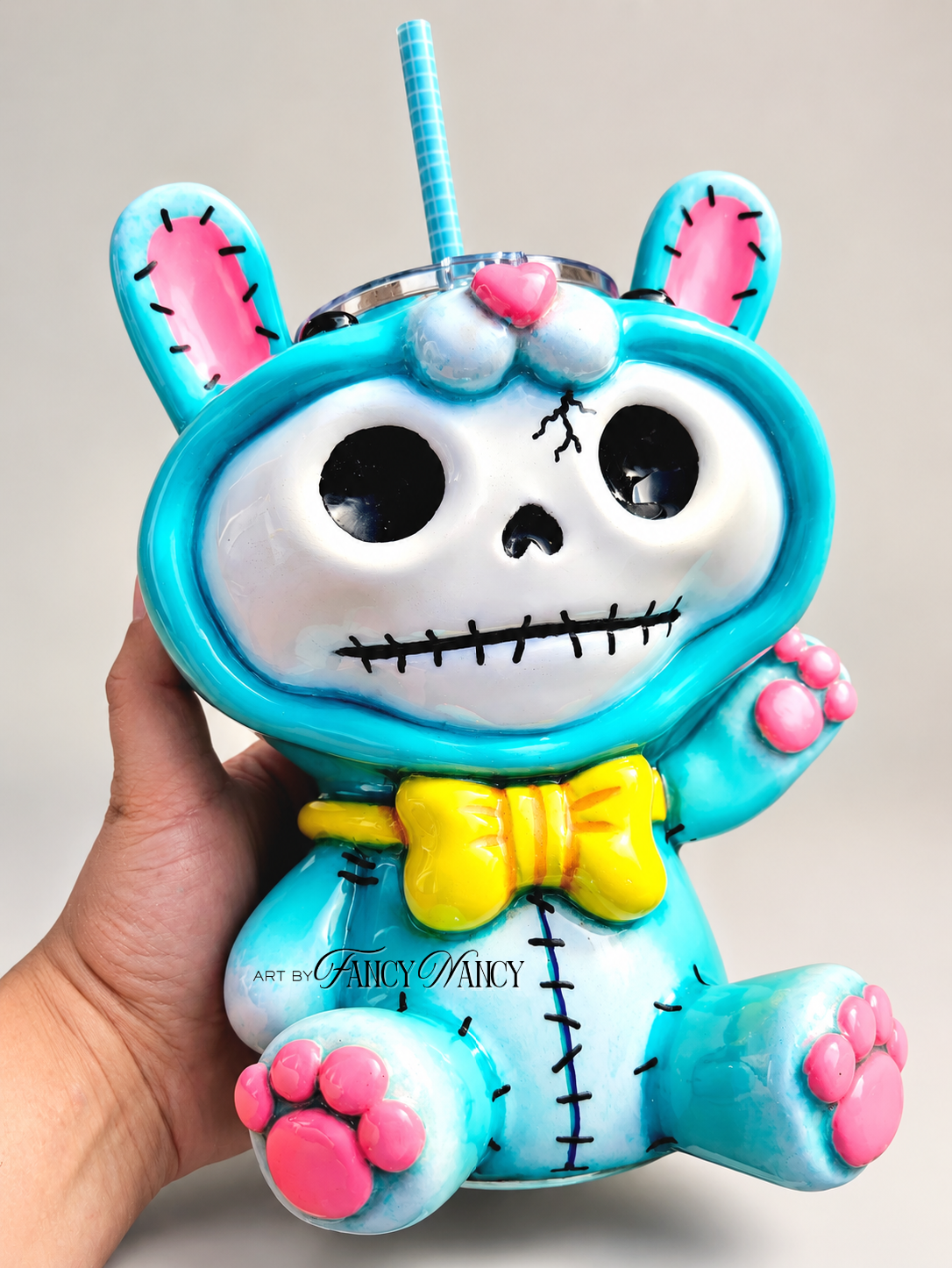 Front view of hand-sculpted Funny Bunny 3D tumbler with skull face and turquoise bunny suit