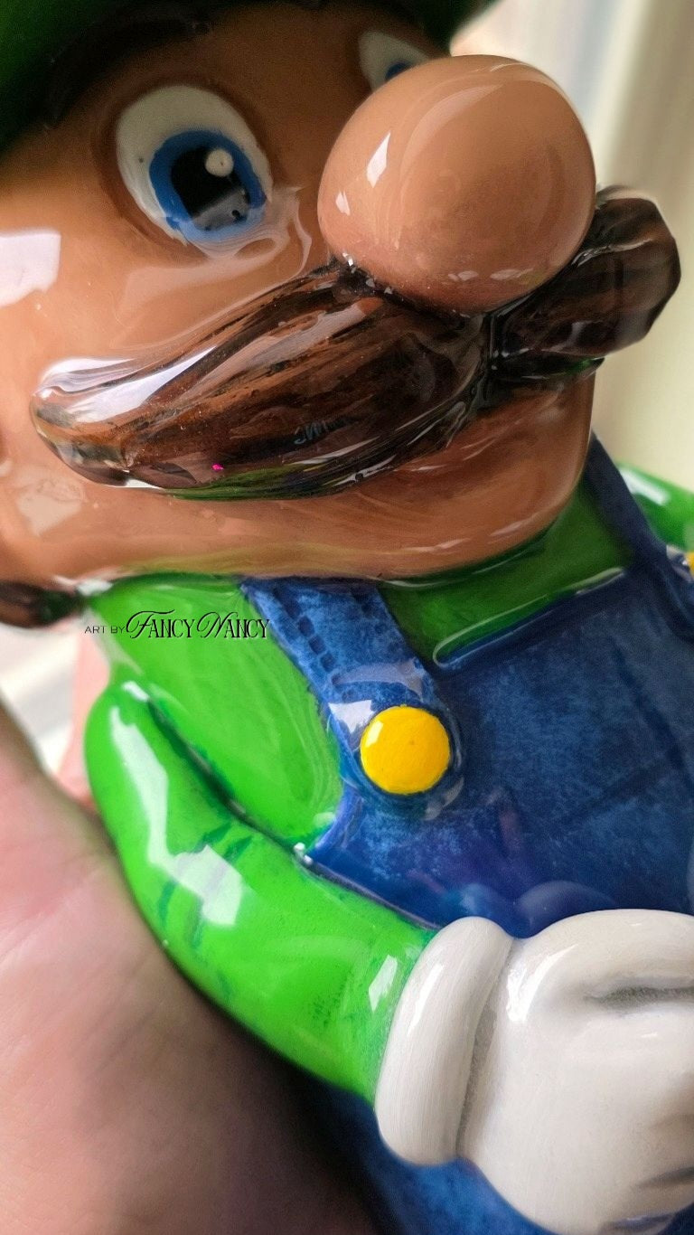 Close-up of hand-sculpted Green Plumber Dude tumbler details and glossy epoxy finish